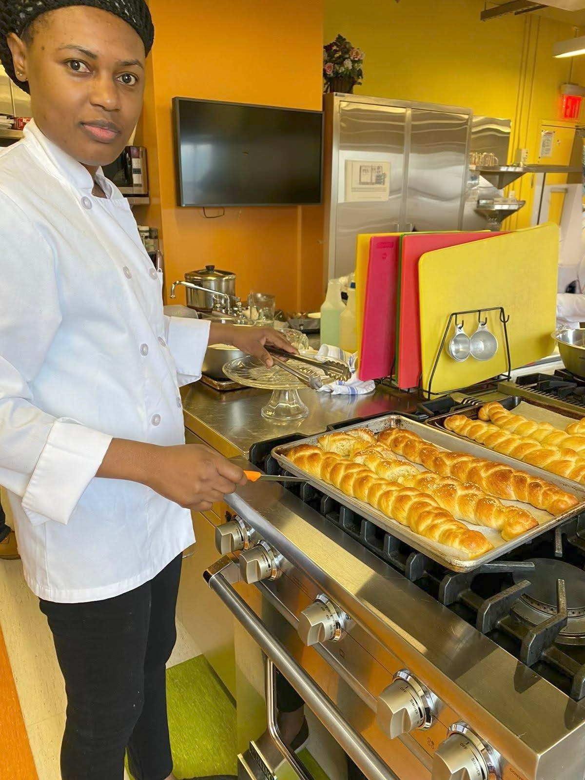 Joedian Reid preparing fresh bread in a professional kitchen