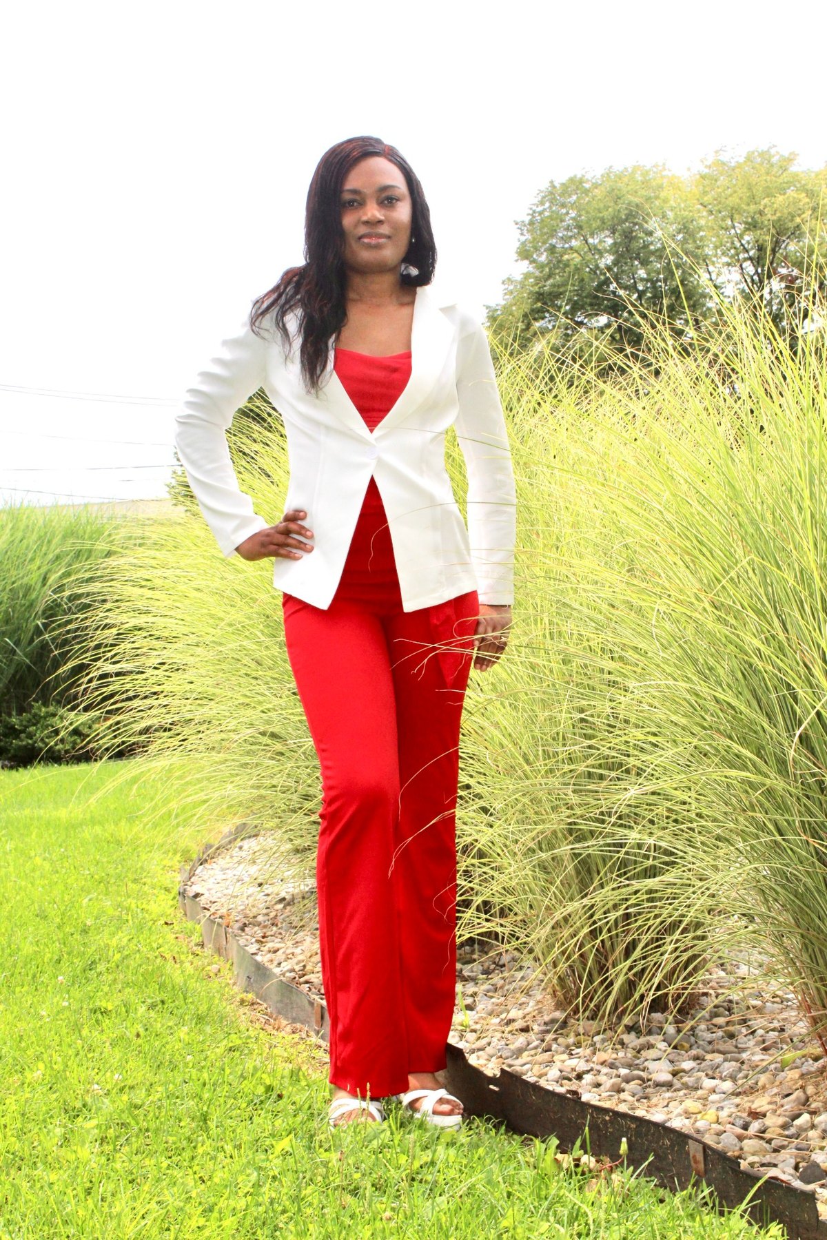 Joedian Reid wearing a white blazer and red outfit outdoors